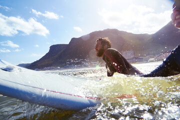 Thinking, couple and relax on surfboard in ocean for travel, fitness adventure and observe waves. People, surfer and ready with board for extreme water sports, tropical holiday and preparation at sea