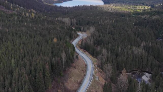 Aerial View of a Winding Mountain Road Leading to a Serene Lake in British Columbia, Canada