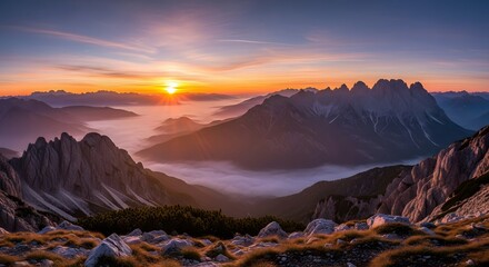 sunrise over rugged peaks with golden light misty valleys and rocky terrain in tranquil mountain scene