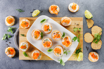 Canapes with fresh cheese and smoked salmon for holiday or event, top view