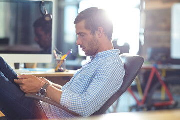 Tablet, research and business man in office for reading review, social media marketing or email. Technology, serious person and marketer in startup for campaign, schedule post or creative development