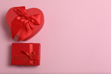 Top view of Christmas gifts with decorations on pink background
