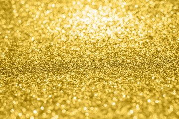 Abstract gold glitter sparkle texture with bokeh background