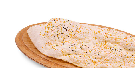 Freshly baked flatbread topped with seeds on a wooden serving board