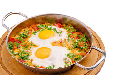 Delicious shakshuka with eggs and fresh herbs served in a skillet