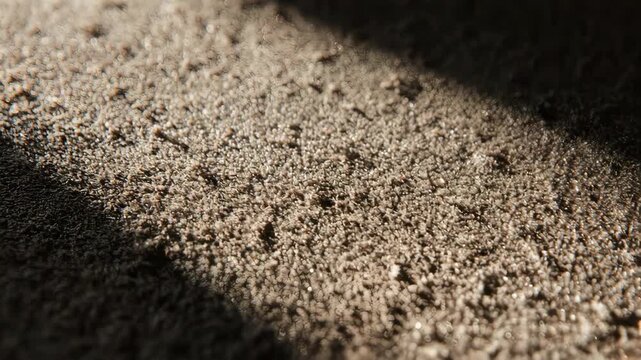 Close-up of rough, textured surface with shadow. Bokeh effect