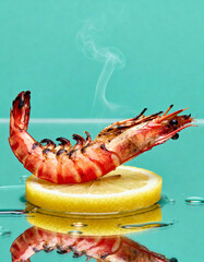 Grilled tiger prawns with lemon on turquoise background