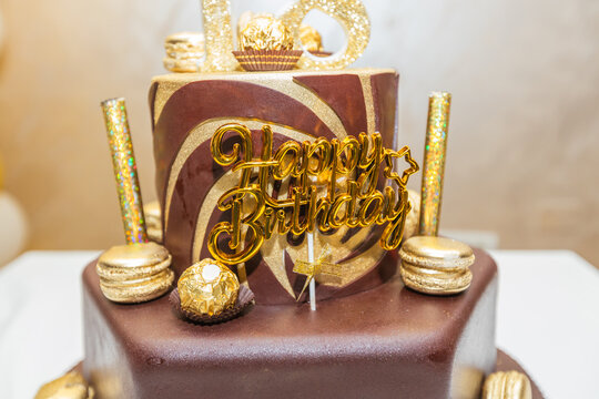 Luxury 18th birthday cake with glittering gold candles and chocolate decoration - Powered by Adobe