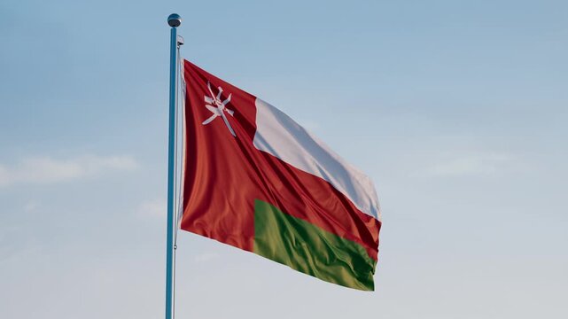 Oman, Muscat: Cinematic Waving National Flag Against Blue Sky