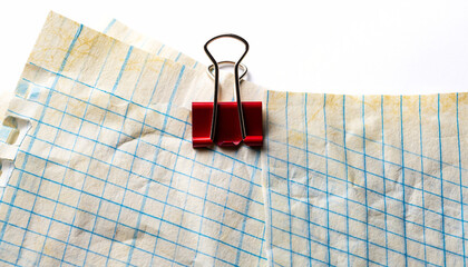 quadrille paper page with red paperclip isolated on white or transparent
