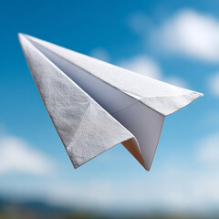 Paper plane flying against a clear blue sky.