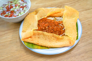 The Vietnamese savory crepe common fillings include a mix of thinly sliced pork belly, shrimp, mung beans, and bean sprouts.