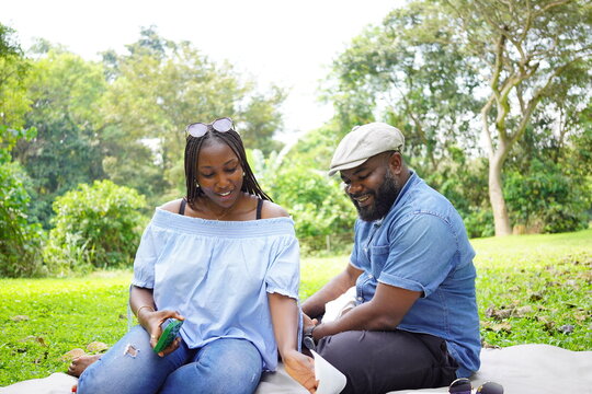 An African couple having a conversation in the park