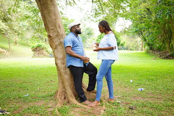 An African couple having a conversation in the park