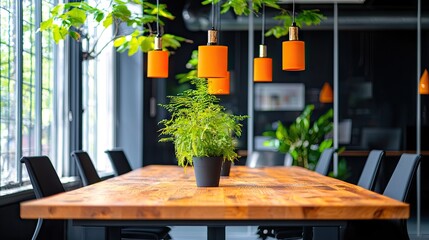 A modern conference room setting with a large wooden table, black chairs, and bright orange pendant lights, complemented by indoor plants.