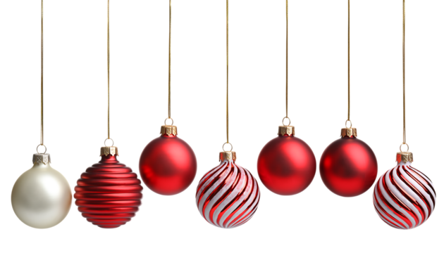 Assortment of seven hanging Christmas ornaments in red and white on a black background