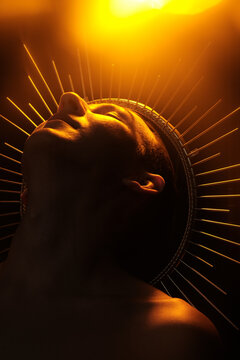 Ethereal figure illuminated by warm golden light in striking pose