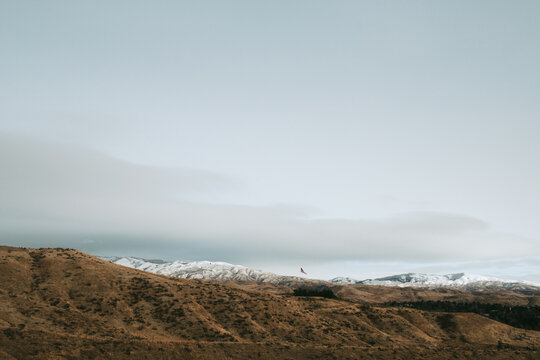 American flag flying over boise idaho foothills