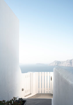A white gate leading to the sea on the island of Santorini
