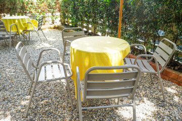 Colorful folding camping chair,wooden and chair set in garden on a sunny day,outdoor seating for restaurant or cafe.