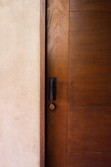 Closeup of wooden door with classic golden handles and ornaments,gold door handle and lock,Beautiful entrance to an expensive home or Luxury hotel,Copy space.