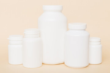 supplement pills with medicine bottle health care and medical top view. Vitamin tablets. Top view mockup bottle for pills and vitamins with green leaves, natural organic bio supplement, copy space