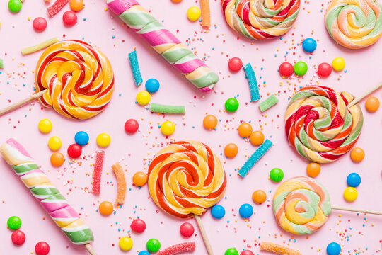 Tasty appetizing Party Accessories Happy Birthday Sweet. Different types of candies on colored background, copy space. Colorful birthday party background