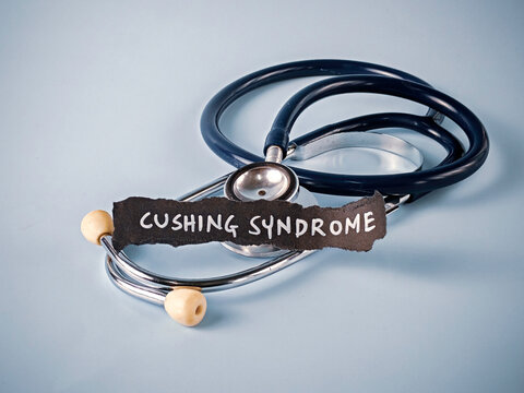 Stethoscope Near Piece of Paper with "Cushing Syndrome" Text on Blue Background: A Concept for Diagnosis and Hormonal Disorder Awareness