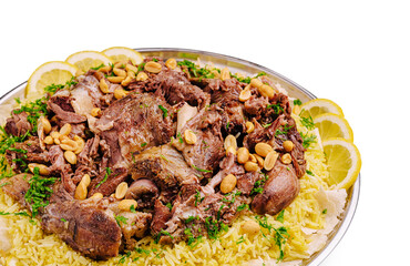 Delicious lamb and rice dish garnished with nuts and lemon slices