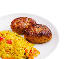 Savory meat patties served with colorful rice dish at a dining table