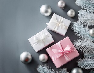 White and pink gift boxes on gray background with copy space with silver and pink glass balls and white pine branches