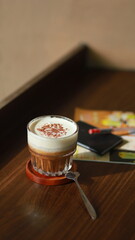 a cup of milk coffee with a layer of salted cream on top