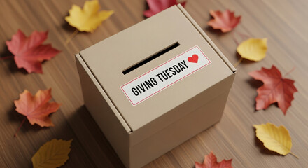 Cardboard donation box with giving tuesday label surrounded by autumn leaves