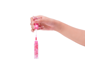 Hand holding shimmering pink lip gloss with glitter and hearts.