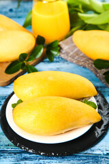 Fresh Ripe Yellow Mango Slices on Plate with Mint Leaves