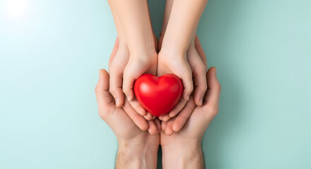 Show your love and compassion with a heart being held by adult and child hands on a soft blue background, perfect for Valentines or family health promos