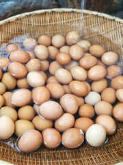 Fresh eggs in the woven basket to stream at the hot spring