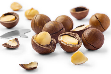Macadamia nut with cracked nut and shell isolated on white background
