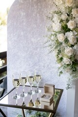 Wedding rings and champagne glasses on elegant ceremony table