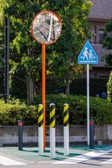 交差点のカーブミラーと交通標識と車避けボラード