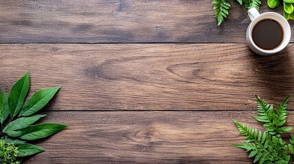 A top-down view of a white coffee mug filled with dark coffee, placed on a wooden surface adorned with fresh green leaves and fern fronds.