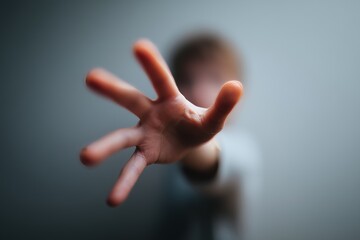 Blurred foreground of an extended hand reaching forward, creating a sense of depth and focus on human connection.