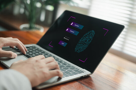 Hands typing on a laptop showing a digital login screen with username, password, and fingerprint authentication, symbolizing cybersecurity, secure access, identity protection.