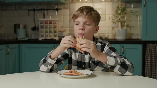 Boy Eating Sandwich at Home