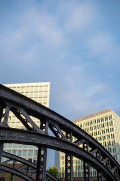 Curved metal bridge structure showing urban architecture geometry with pattern, contrast and detail shaping a refined graphic infrastructure scene