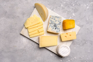 Gourmet cheese platter with craft cheese assortment on a marble platter. hard cheeses, mold cheese, gorgonzola, pecorino, Emmental, Roquefort ,  cheddar
