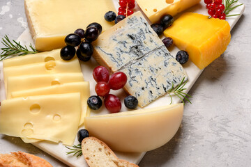 Gourmet cheese platter with craft cheese assortment on a marble platter. hard cheeses, mold cheese, gorgonzola, pecorino, Emmental, Roquefort ,  cheddar