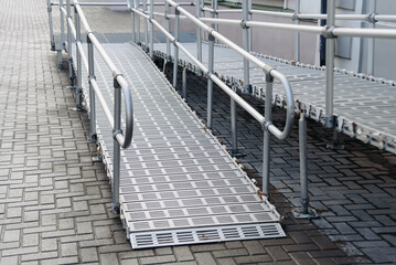 Obraz premium ramp on stairs for baby strollers, bicycles and wheelchairs, accessible urban environment