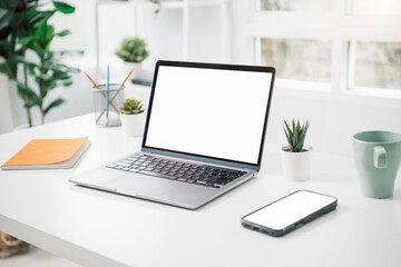 Fototapeta premium Laptop and phone mockup on desktop table home office workspace emplate for your text Clipping paths included for background and device screen