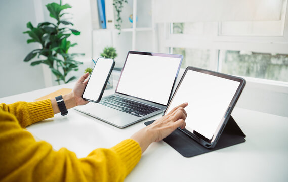 Digital multitasking workspace with mockup laptop tablet and smartphone enabling seamless cross-device workflow integration and enhanced modern productivity supported by active hand interaction